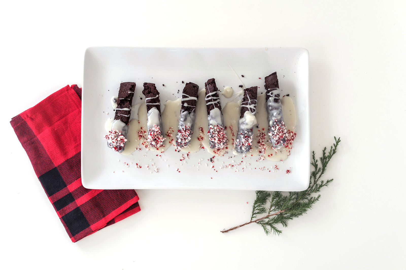 Top view of Miss Jones Baking Co Chocolate Peppermint Cake Mix Biscotti with a hand over it
